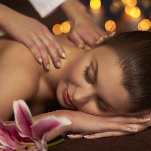 Professional Balinese massage therapist providing a relaxing full-body home spa massage in a luxury Dubai apartment with premium oils and a peaceful wellness atmosphere.
